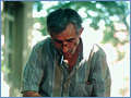 Fisherman repairing fish net